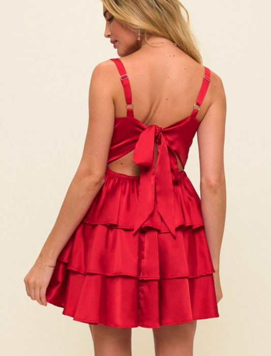 Red satin dress with open back on a beige background